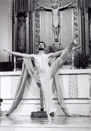 Fr. Robert Ver Eecke dancing in front of an altar